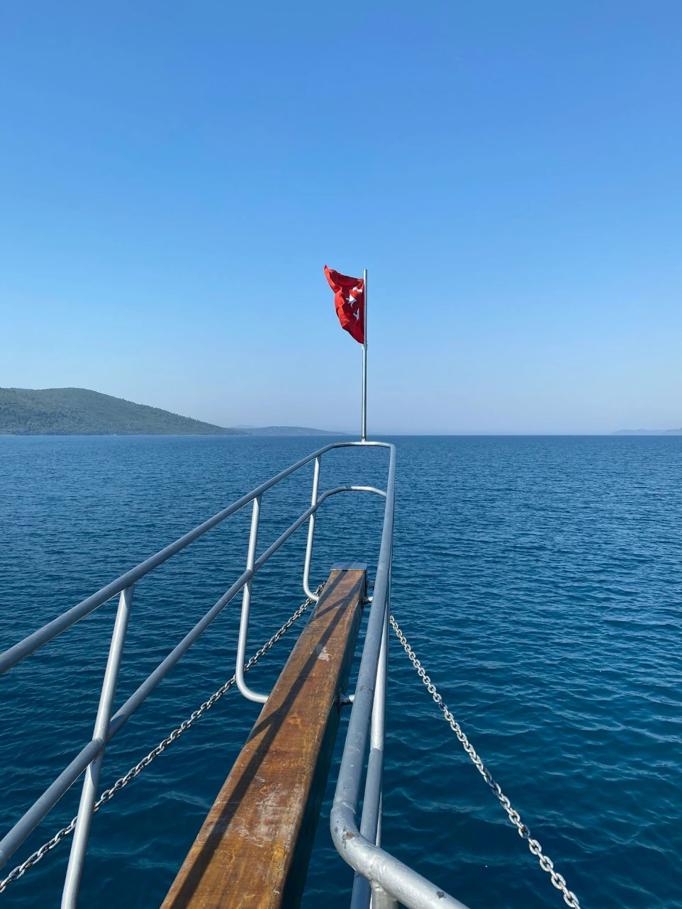 red and white flag on stainless steel railings